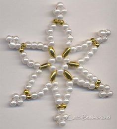 a white and gold beaded snowflake ornament