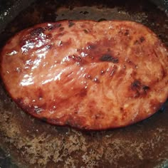 some food is cooking in a skillet on the stove top, and ready to be cooked