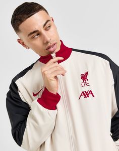 Get set for matchdays with this men's Liverpool FC Anthem Jacket from Nike. In a Light Orewood Brown colourway with Black and Gym Red panels, this jacket is made with smooth, lightweight poly fabric for lasting comfort. Engineered with sweat-wicking Dri-FIT technology, it features a full-zip fastening with a stand-up ribbed collar for added coverage and a signature sportswear feel. With stretchy ribbed trims to secure the fit and pockets up front, it's finished with signature Nike branding at the chest and the legendary Liverpool FC team crest. Machine washable. Liverpool Fc Team, Nike React Vision, 270 Nike, Nike Branding, Red Panels, Football Training, Black Nike, Football Boots, Jd Sports