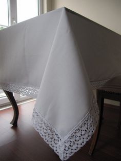 a white table cloth with lace on it