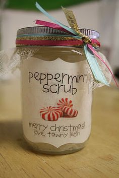 peppermint scrub jar with candy canes in it on a wooden counter top