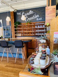 the inside of an ice cream shop with wooden tables and chairs