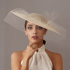 Elegant Cream wedding hat with veil. The cream hat is wrapped with crystals veil that ends in a bow.  This ivory hat is perfect for any special occasion, Tea Party, Derby, races or wedding. It is mounted on a headband that allows to tilt the sunhat to the liking of each one. Any color headdress can be changed to order. The sunhats are ship by courier to all countries. 1€ of each Order will be donated to Cancer Research. Destinations              Processing time                     Delivery time Brides Veil, Royal Blue Fascinator, Veil Hat, Race Day Hats, Ivory Hat, Hat With Veil, Tea Hats, Hat Cream, Royal Ascot Hats