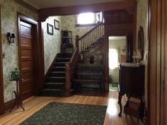 an entry way with stairs and carpeted flooring