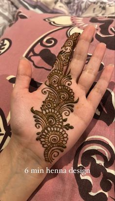 someone is holding their hand with henna on it