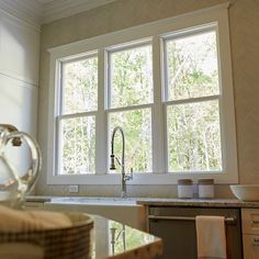 a kitchen with a sink, dishwasher and window