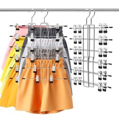 an assortment of skirts hanging on a rack with clips to hang them from the ceiling