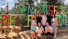 a group of people standing in front of a sign