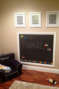 a child's room with chalkboard and toys on the floor