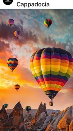 colorful hot air balloons flying in the sky over rocks and mountains at sunset, cappadocia