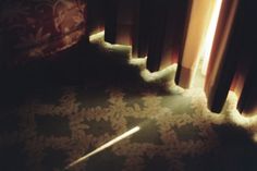 sunlight shining through curtains onto the floor