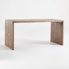 a wooden table sitting on top of a white floor