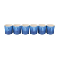 six blue glass cups with white rims