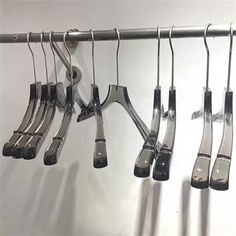 an assortment of kitchen utensils hanging on a rack