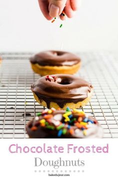 chocolate frosted doughnuts with sprinkles are on a cooling rack