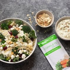 two bowls filled with food next to a bag of yogurt and granola