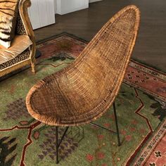 a wicker chair sitting on top of a green rug