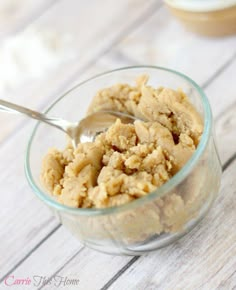 a glass bowl filled with oatmeal on top of a wooden table