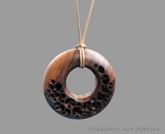 Boho Wood Necklace. This wood round necklace was made from walnut wood, carved, polished and finished with fine tung oil. This boho style wood necklace can be perfect gift for man or gift for woman.  THIS NECKLACE CAN BE COMBINED WITH EARRINGS THAT WOULD MATCH,  BY YOUR ORDER! The length of the cord is about 30 inches (77 cm), but it can be regulated by the movable knot. Materials utilised: pear wood, waxed cord Production method  100% hand made by natural materials. ABOUT ME My name is Nikolin Georgiev and I live in Sofia, Bulgaria. I love creating beauty therefore I make jewelry. I love colours and stones' emanation. I also love the soft warmth of wood as well as the glitter of the buffalo horn. I like natural materials and I enjoy combining them. I use whatever Mother Nature had given u Walnut Necklace, Pear Wood, Tung Oil, Round Necklace, Wood Necklace, Nature Inspired Jewelry, Wood Pendant, Wood Carved, Inspired Jewelry