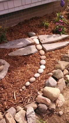 a garden with rocks and flowers in it