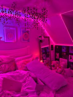 a bedroom with pink lights and stuffed animals on the bed