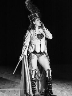 a woman dressed in costume standing on a stage