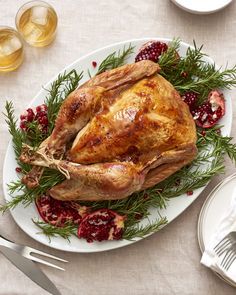 a turkey on a plate with cranberry sauce and silverware next to it