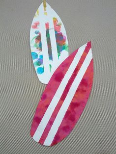 two pieces of paper that have been made to look like surfboards