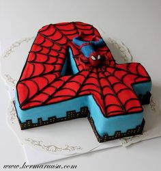 a spiderman cake with the number four on it