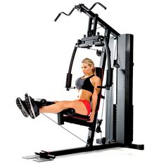 a woman is sitting in the gym machine