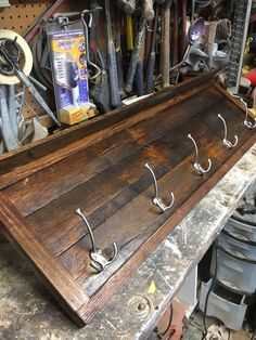 a wooden shelf with hooks on it in a shop