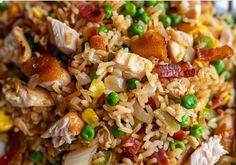 a plate with rice, peas, and chicken on it is ready to be eaten