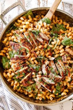 a skillet filled with pasta and meat