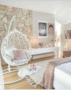 a bedroom with a bed, chair and pictures on the wall above it is decorated in pink and white