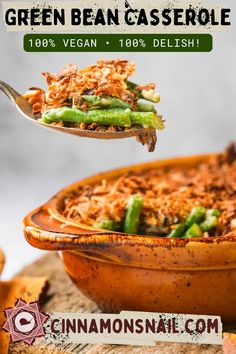 the green bean casserole is being lifted with a serving spoon from a dish