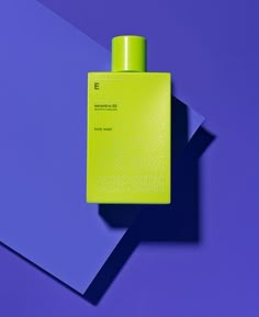 a bottle of cologne sitting on top of a purple and blue surface