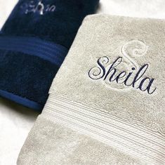 two towels with the word sheila on them are sitting next to each other in blue and white