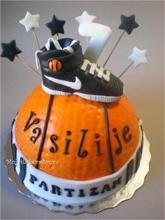 an orange cake decorated with black and white nike shoes, stars, and tennis balls