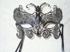 Handmade black laser cut metal mask from Venice, Italy. Ready for decorating.  Add your own art work to these masks. They can be painted, decorated with hot glue, glitter, jewels, feathers etc. Mask has satin ribbons for wearing.  This mask is 7.5 inches wide and 4.5 inches high  Great for classroom projects, group projects, birthday parties etc... Black And Gold Masquerade Mask, Masquerade Mask Black, Masquerade Ideas, Gold Masquerade Mask, Venetian Masquerade Masks, Metal Mask, Feather Mask, Venetian Masquerade, Halloween Masquerade