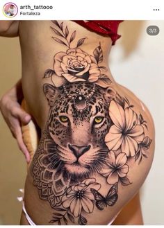 a woman with a tattoo on her stomach has a leopard and flowers tattooed on it