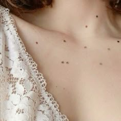 a woman with very small stars on her chest