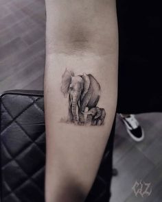 an elephant tattoo on the arm