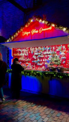 people standing in front of a christmas display