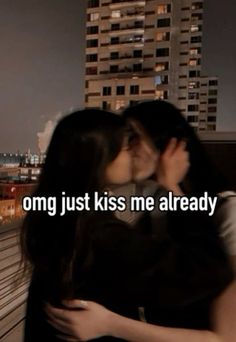 two people kissing each other in front of a cityscape with the words, omg just kiss me already