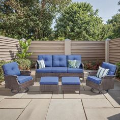 an outdoor patio with blue cushions and furniture