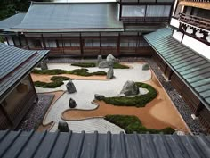 an aerial view of a japanese garden with rocks and moss growing on the ground in front of it