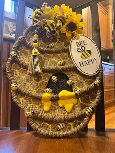 a bee happy wreath with sunflowers and bees hanging from it's sides