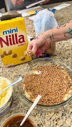 someone is making a pie with nuts on it and other ingredients around the cake dish