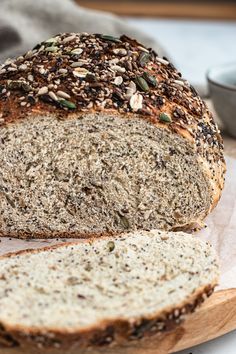 a loaf of bread sitting on top of a wooden cutting board