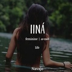 a woman is sitting in the water with her back turned to the camera and texting ina feminine i e - nah life